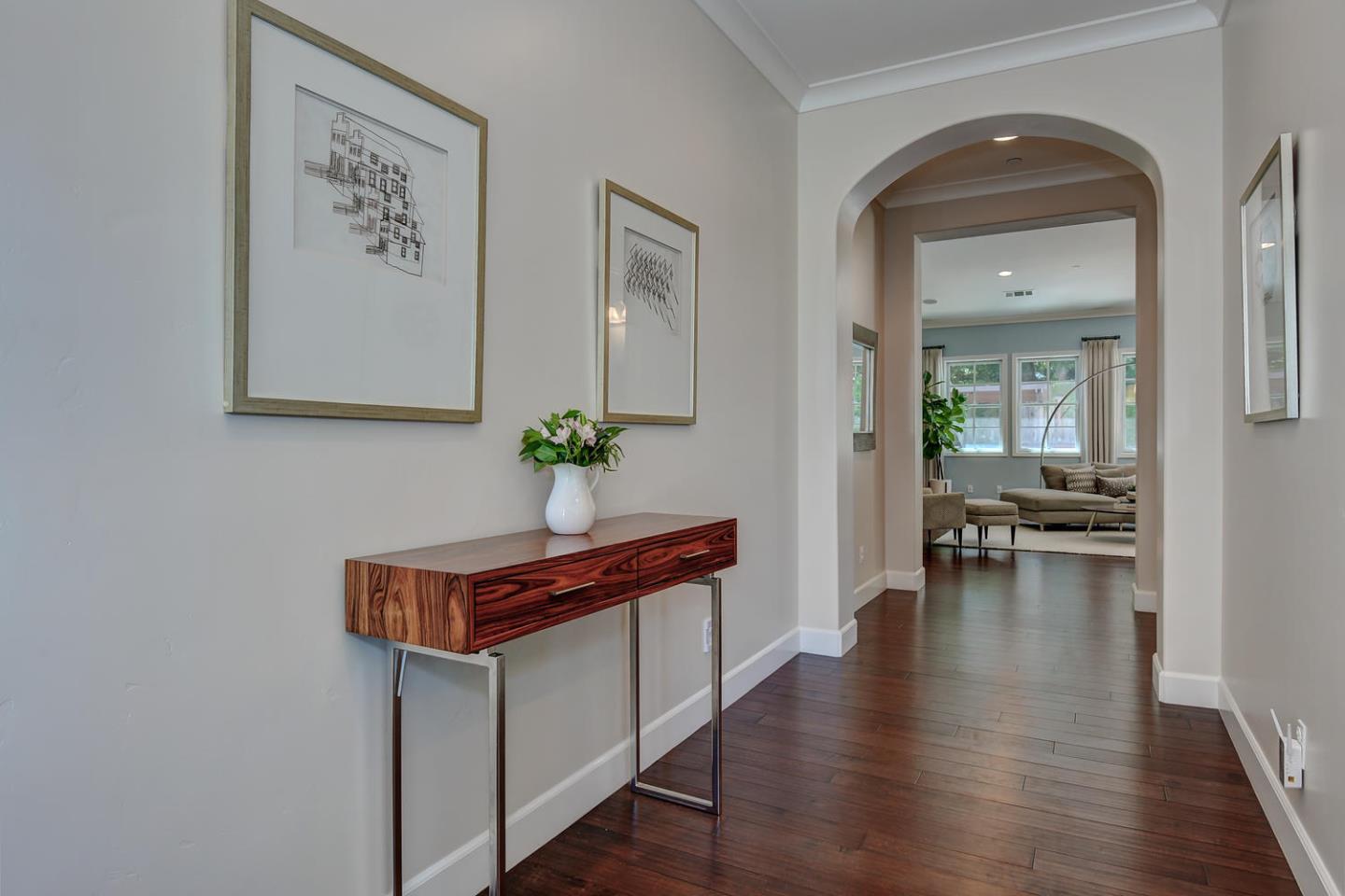 181 Mansfield Drive Mountain View, CA 94040 - Photo 5 of 44 a hallway with couches and a dining table with wooden floor