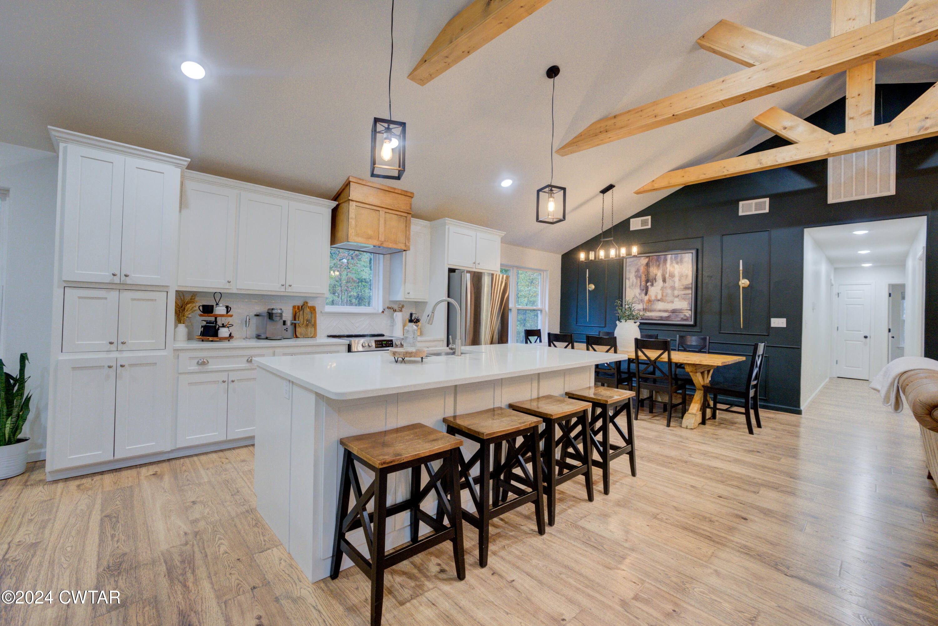 3922 Old Medina Road Medina, TN 38355 - Photo 12 of 51 a kitchen with stainless steel appliances a table chairs refrigerator and cabinets