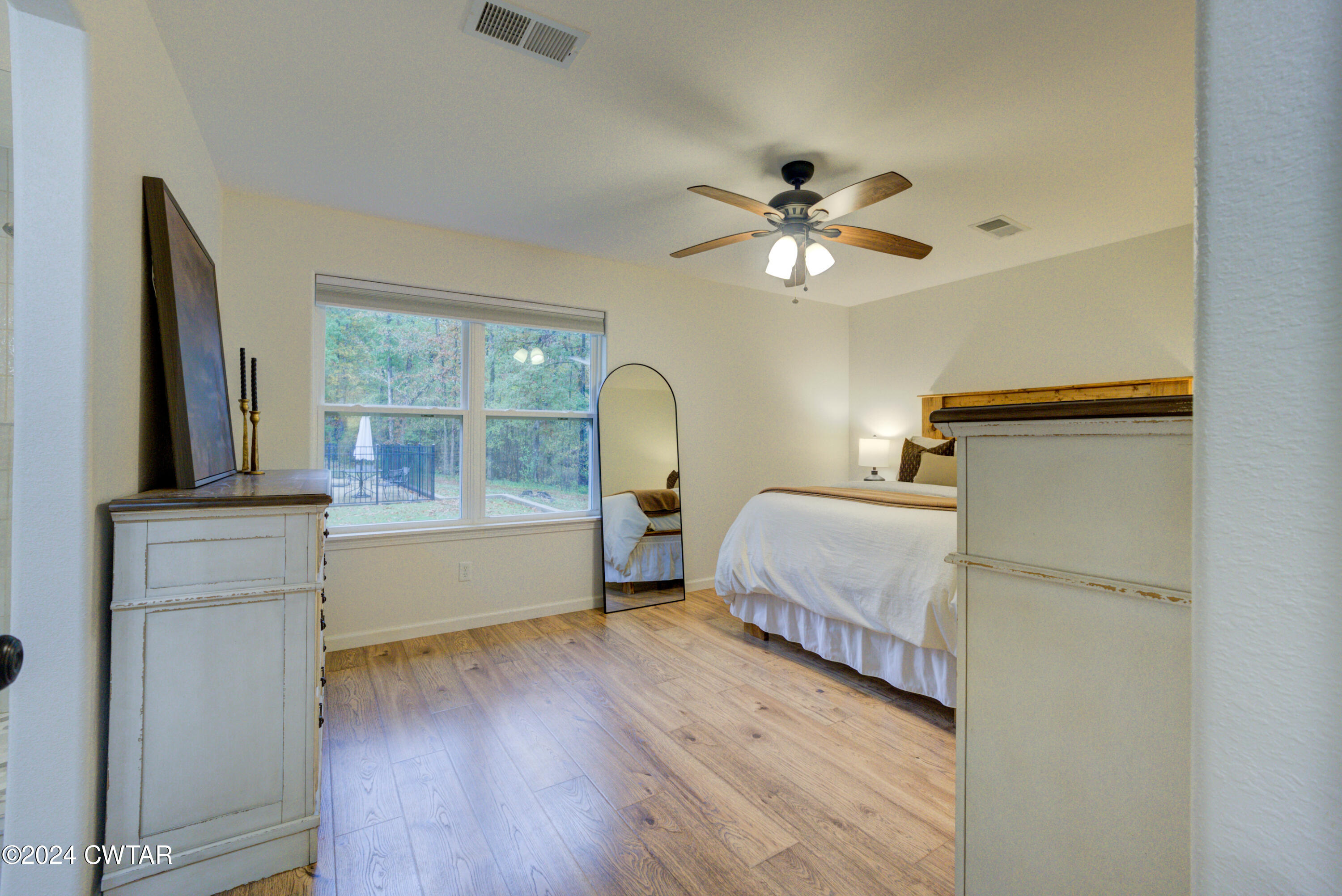 3922 Old Medina Road Medina, TN 38355 - Photo 31 of 51 a bedroom with a bed and a chandelier