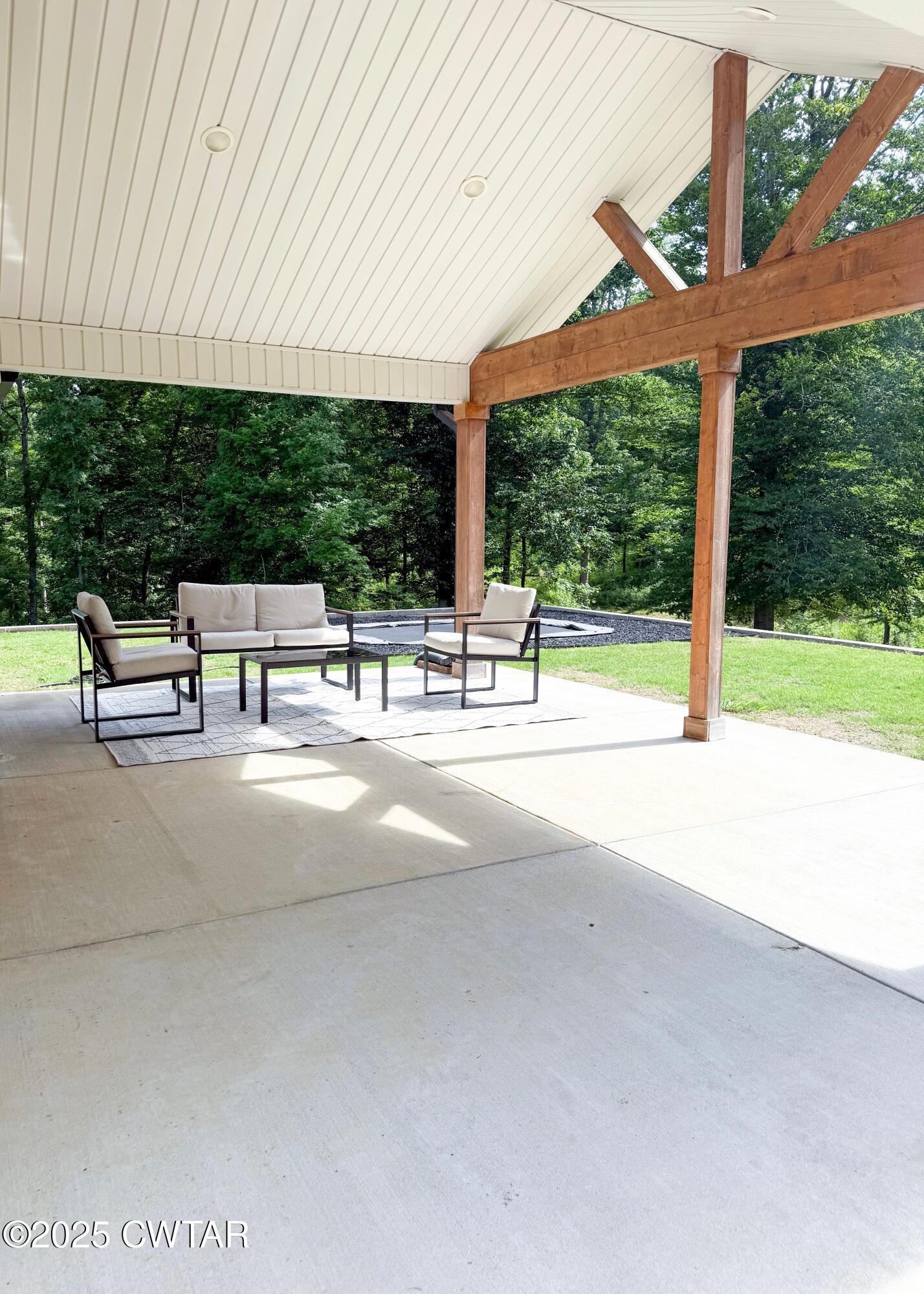 3922 Old Medina Road Medina, TN 38355 - Photo 42 of 51 a view of a patio with table and chairs under an umbrella