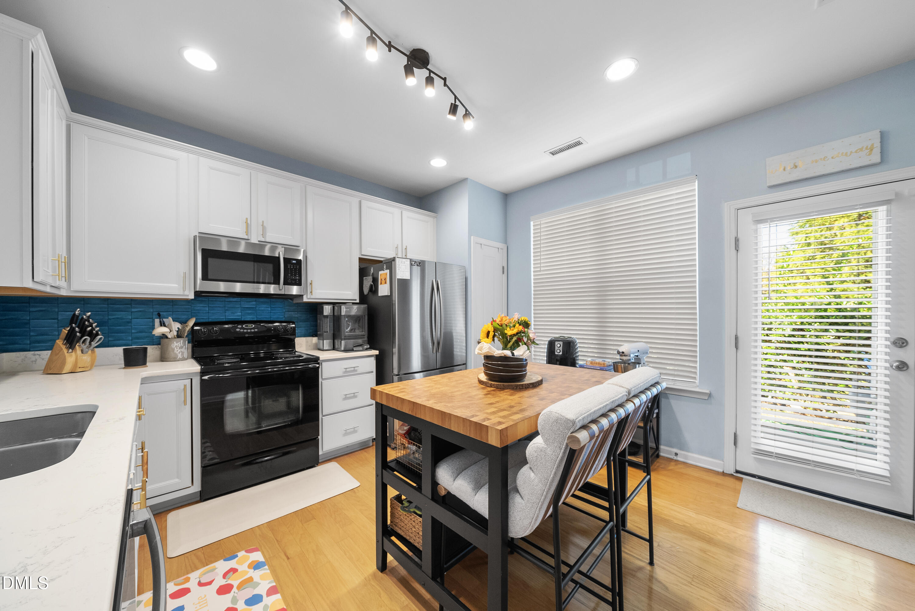 6025 History Trail Raleigh, NC 27612 - Photo 11 of 33 a kitchen with sink cabinets and wooden floor