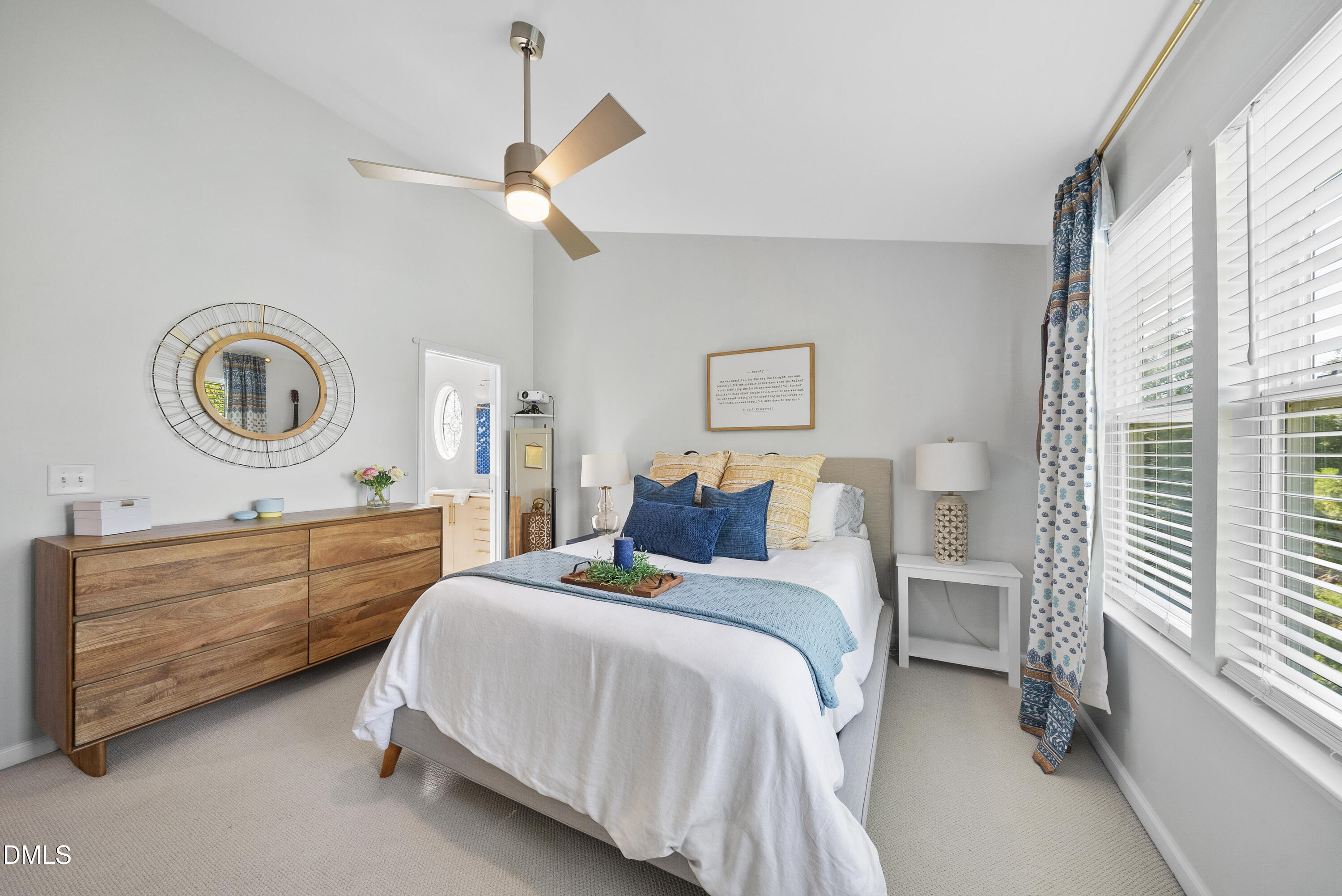 6025 History Trail Raleigh, NC 27612 - Photo 22 of 33 a bedroom with a bed a chandelier and a mirror on the dresser