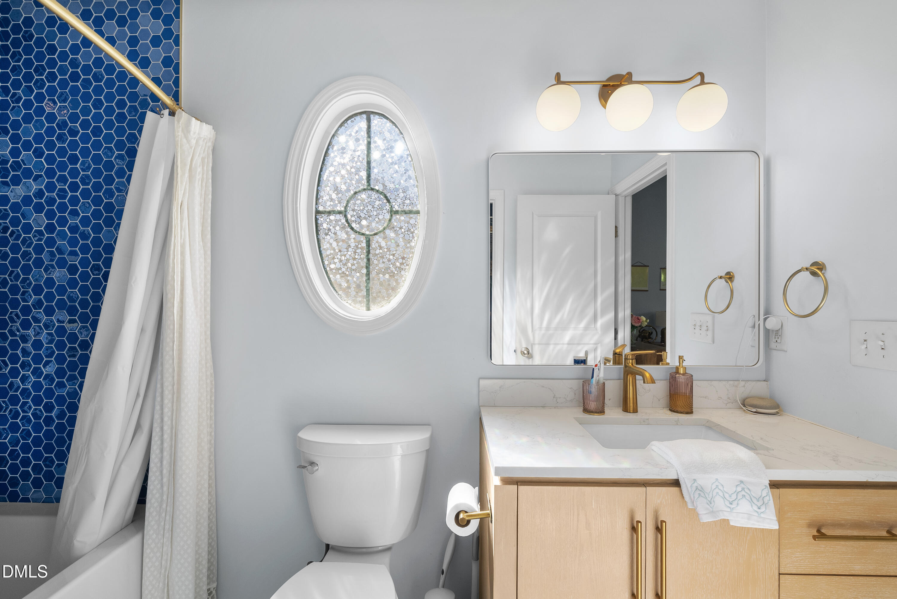 6025 History Trail Raleigh, NC 27612 - Photo 25 of 33 a bathroom with a toilet a sink and mirror