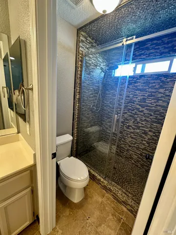 a bathroom with a toilet and a shower