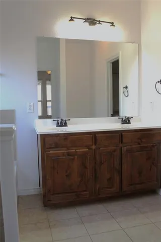 a bathroom with a sink vanity and a mirror