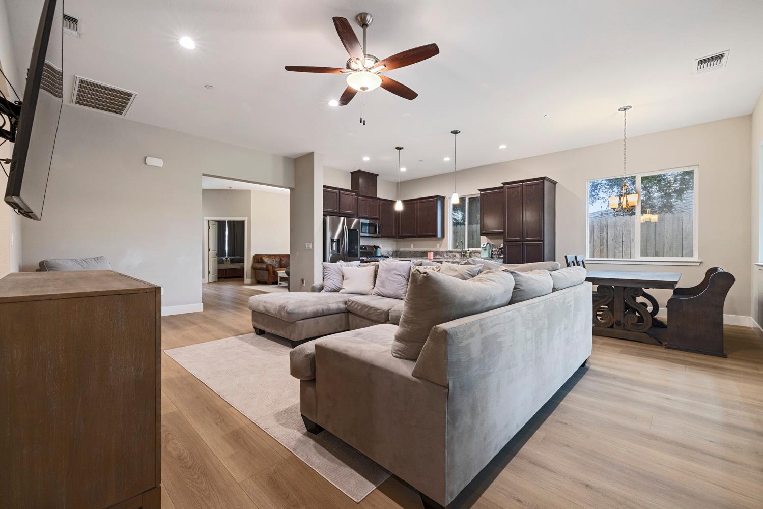 3700 Colorado Avenue Turlock, CA 95382 - Photo 11 of 46 a living room with furniture kitchen view and a wooden floor