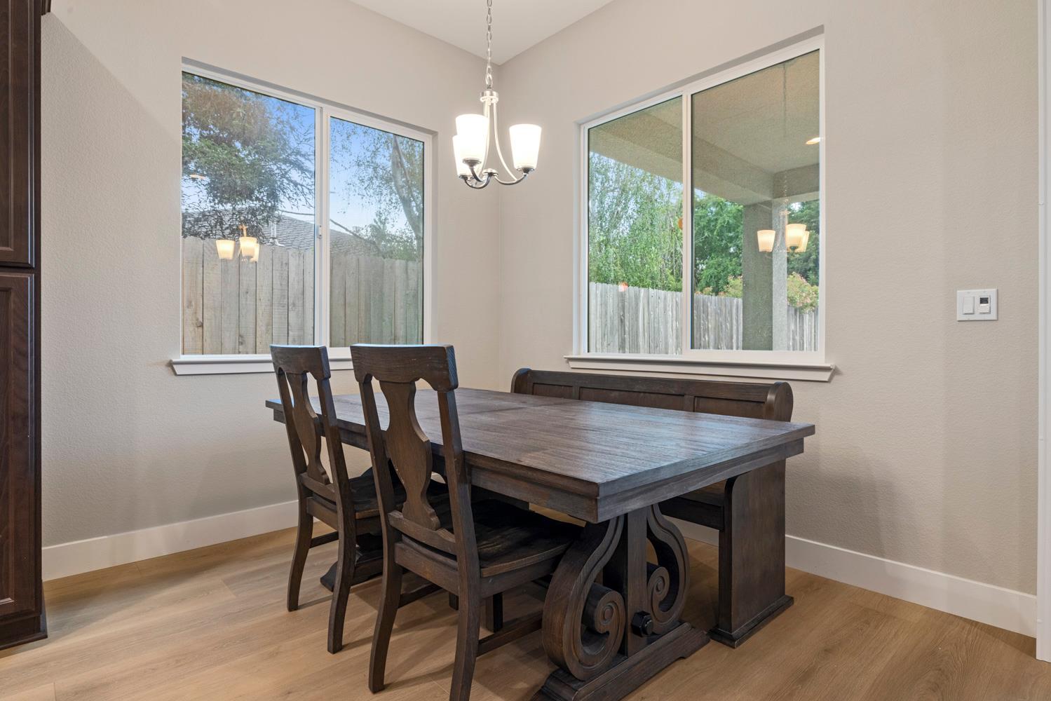 3700 Colorado Avenue Turlock, CA 95382 - Photo 16 of 46 a dining room with furniture a chandelier and wooden floor
