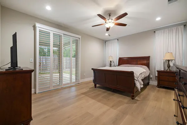 a bedroom with a large bed and a large window