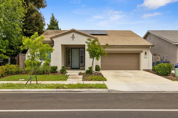 a front view of a house with a yard