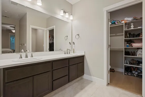 a bathroom with a double vanity sink and a mirror