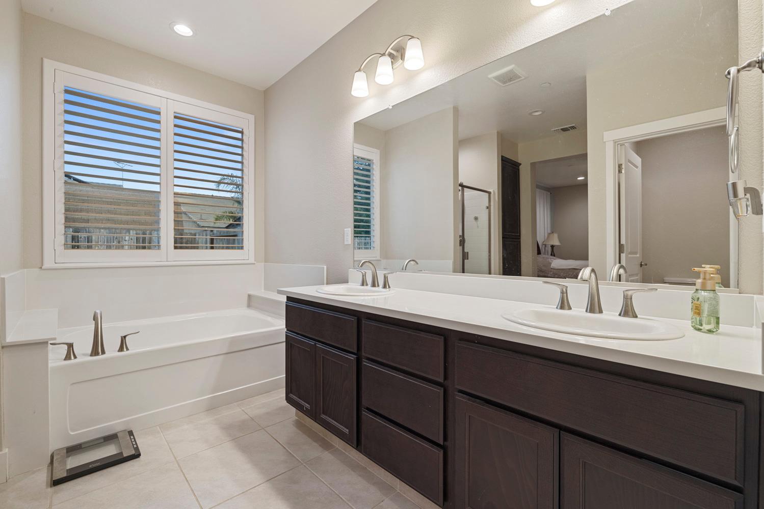 3700 Colorado Avenue Turlock, CA 95382 - Photo 22 of 46 a bathroom with a tub double sink window and mirror