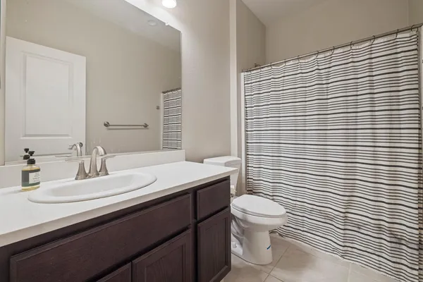 a bathroom with a sink a toilet and mirror