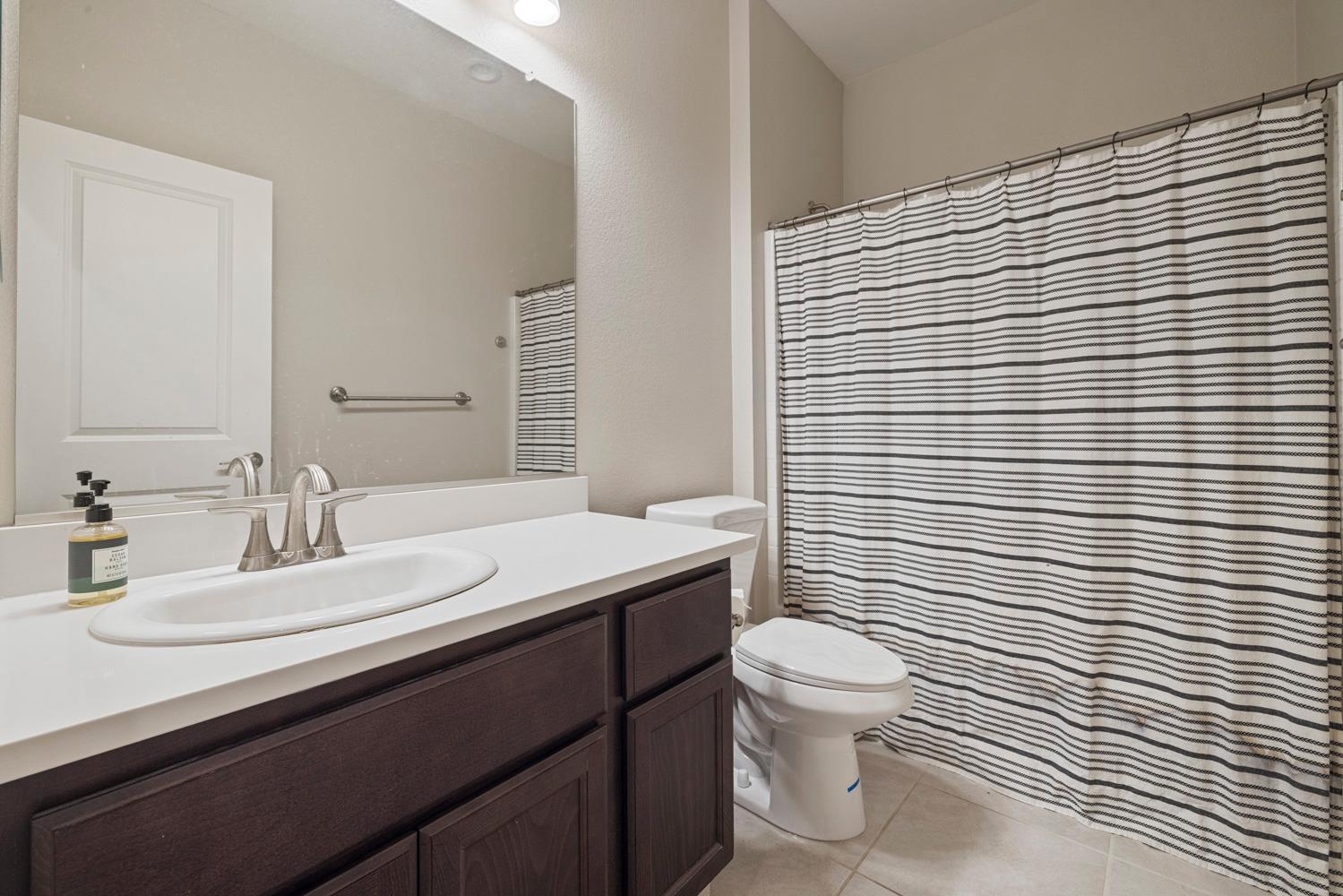 3700 Colorado Avenue Turlock, CA 95382 - Photo 24 of 46 a bathroom with a sink a toilet and mirror