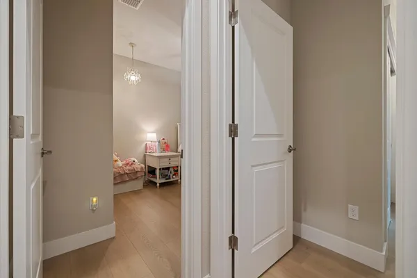 a bedroom with a bed and a chandelier
