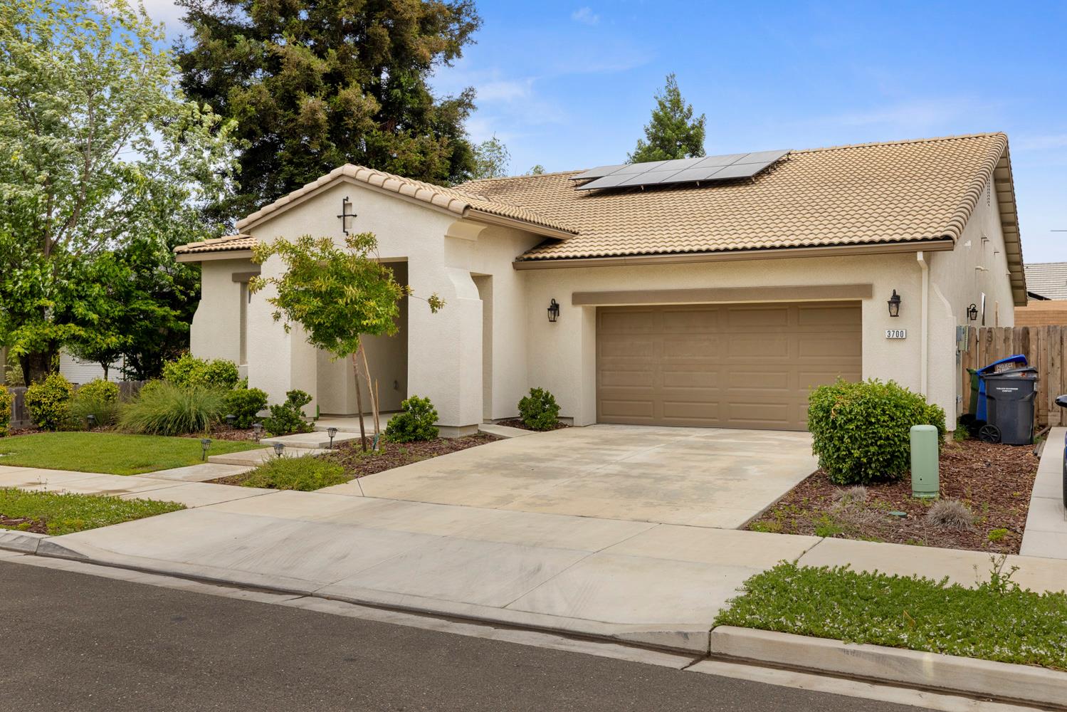 3700 Colorado Avenue Turlock, CA 95382 - Photo 3 of 46 a view of white house with a yard and potted plants