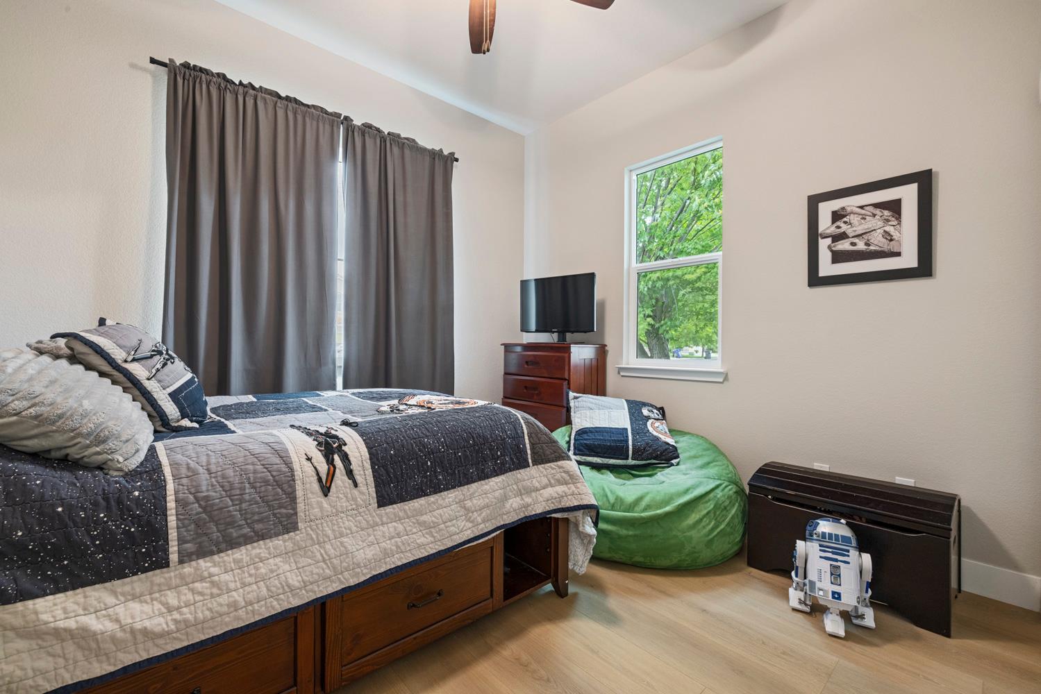 3700 Colorado Avenue Turlock, CA 95382 - Photo 8 of 46 a bedroom with a bed and a lounge chair