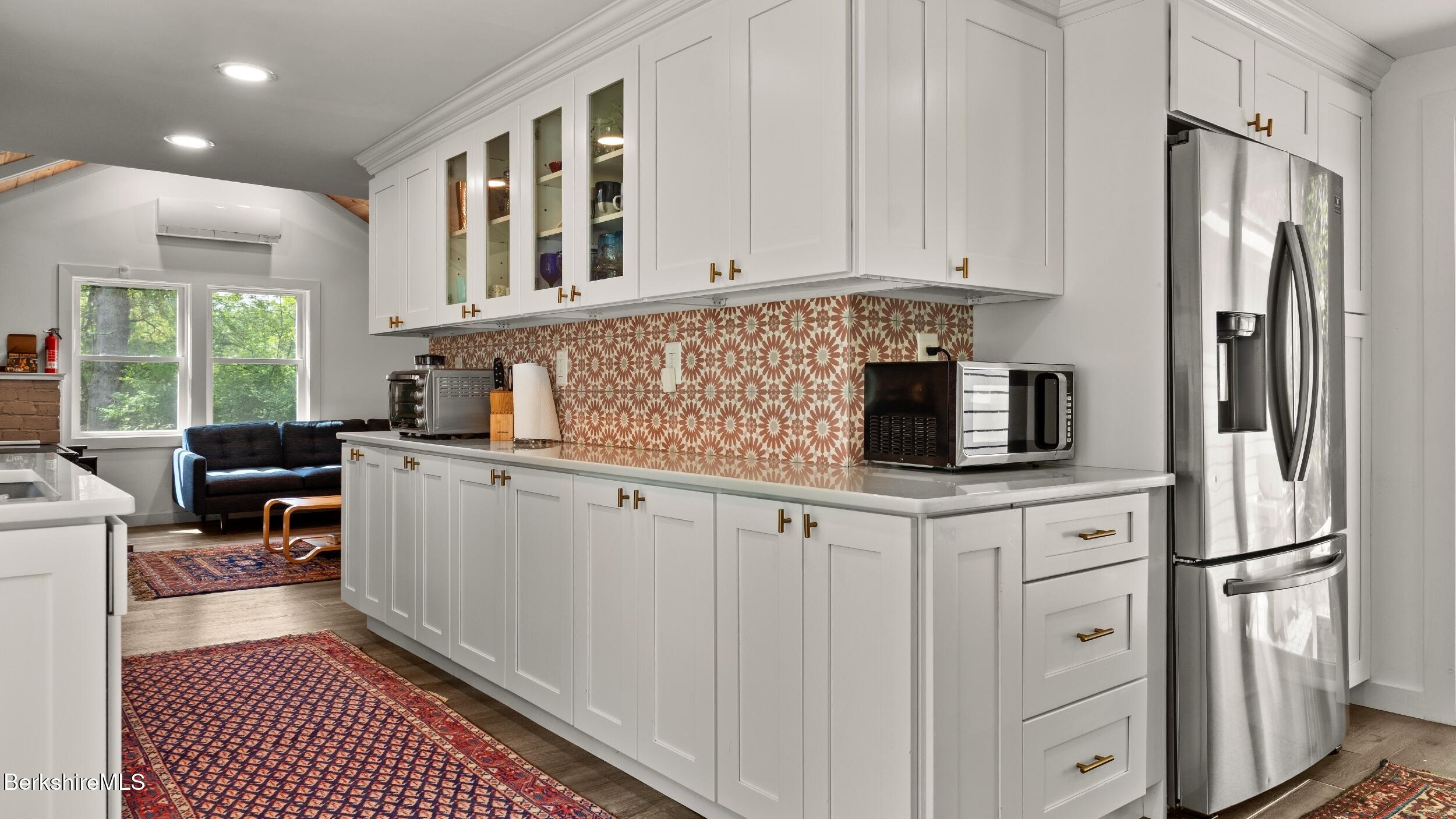 418 Monterey Road Great Barrington, MA 01230 - Photo 9 of 28 a kitchen with stainless steel appliances a refrigerator sink and cabinets