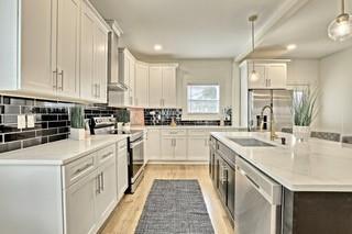 825 Beryl Street Southwest Atlanta, GA 30310 - Photo 14 of 19 a kitchen with kitchen island granite countertop white cabinets sink and white appliances