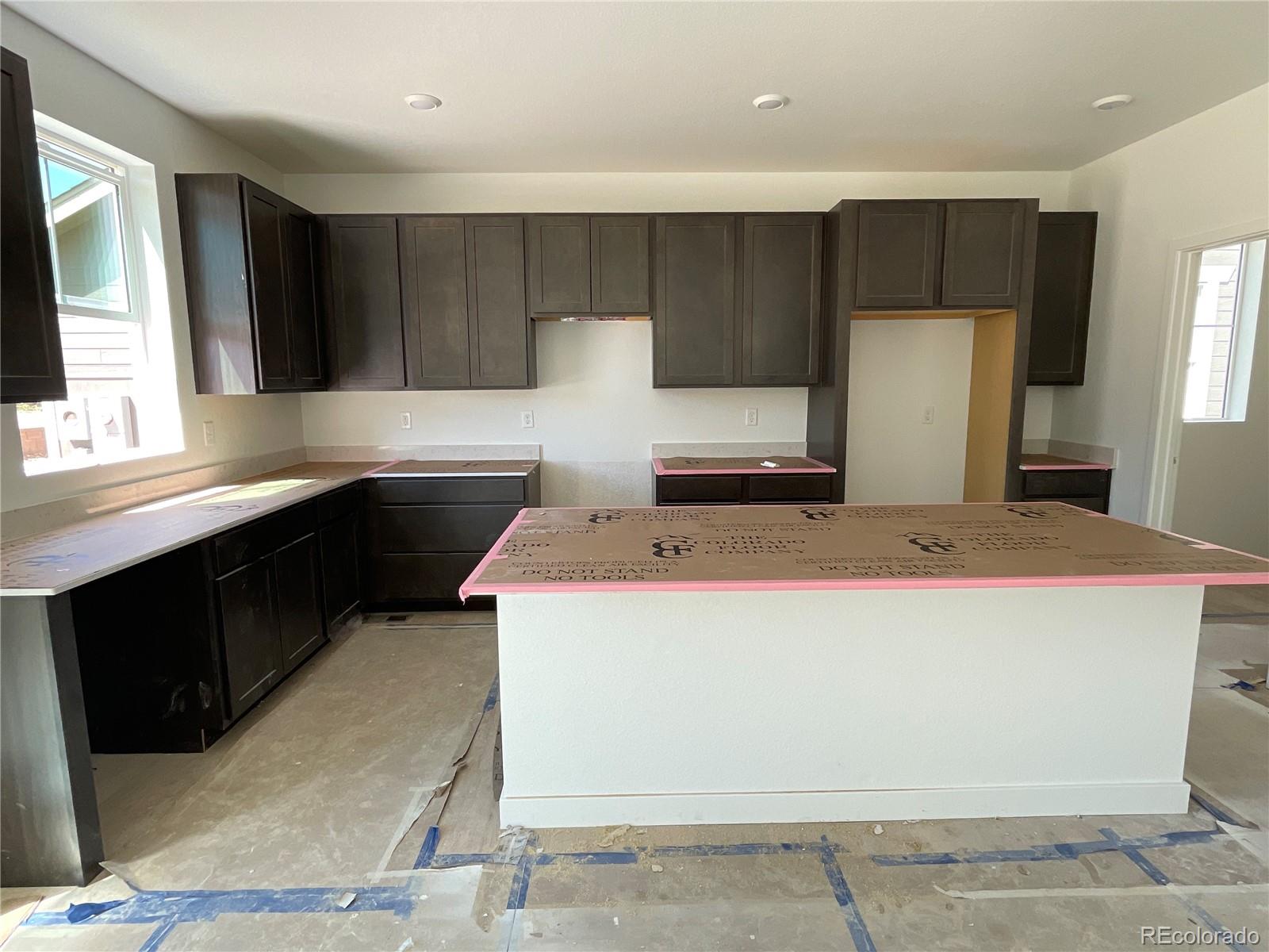 12901 Range Street Firestone, CO 80504 - Photo 2 of 12 a kitchen with a sink a stove and refrigerator