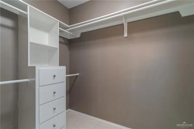 a view of walk in closet with empty racks