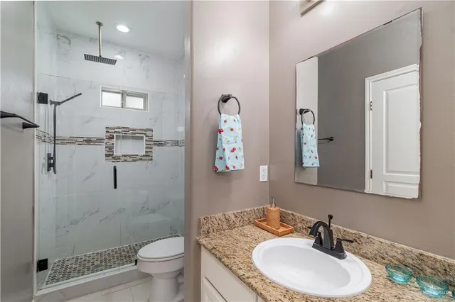 a bathroom with a sink toilet and shower
