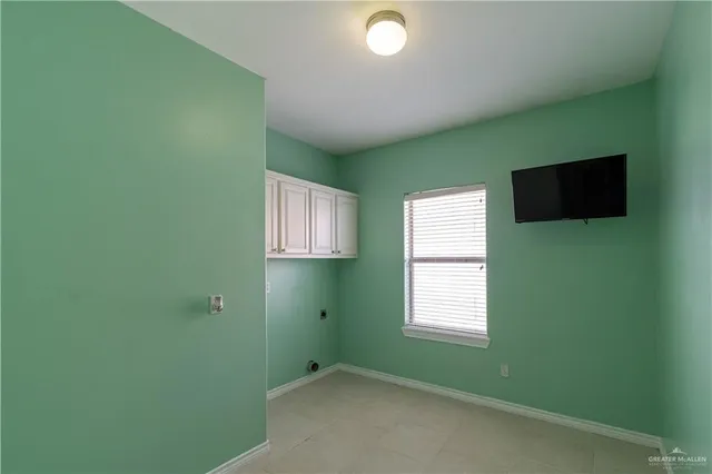 a view of a room that has a window and a flat screen tv