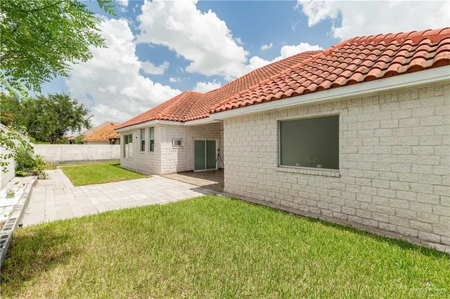 a backyard of a house with table and chairs