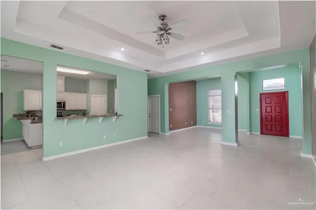 a view of a room with cabinet and a ceiling fan