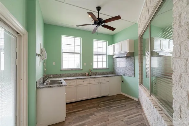 a large white kitchen with a large window