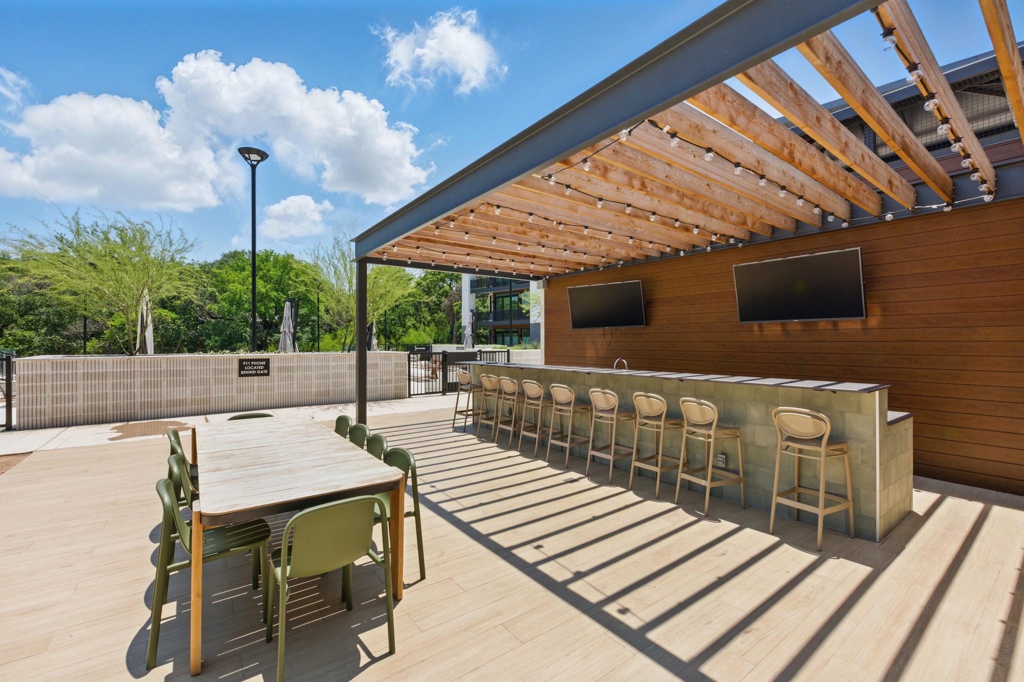 2209 South 1st Street, Unit 321 Austin, TX 78704 - Photo 40 of 40 Wooden terrace with an outdoor bar and dining area and a pergola