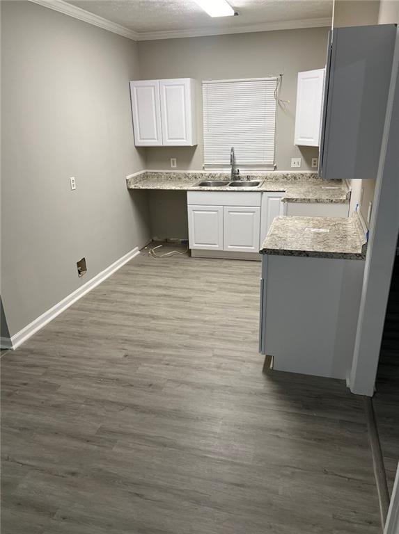 2716 Spenola Street Columbus, GA 31906 - Photo 6 of 11 a kitchen with granite countertop a sink cabinets and wooden floor