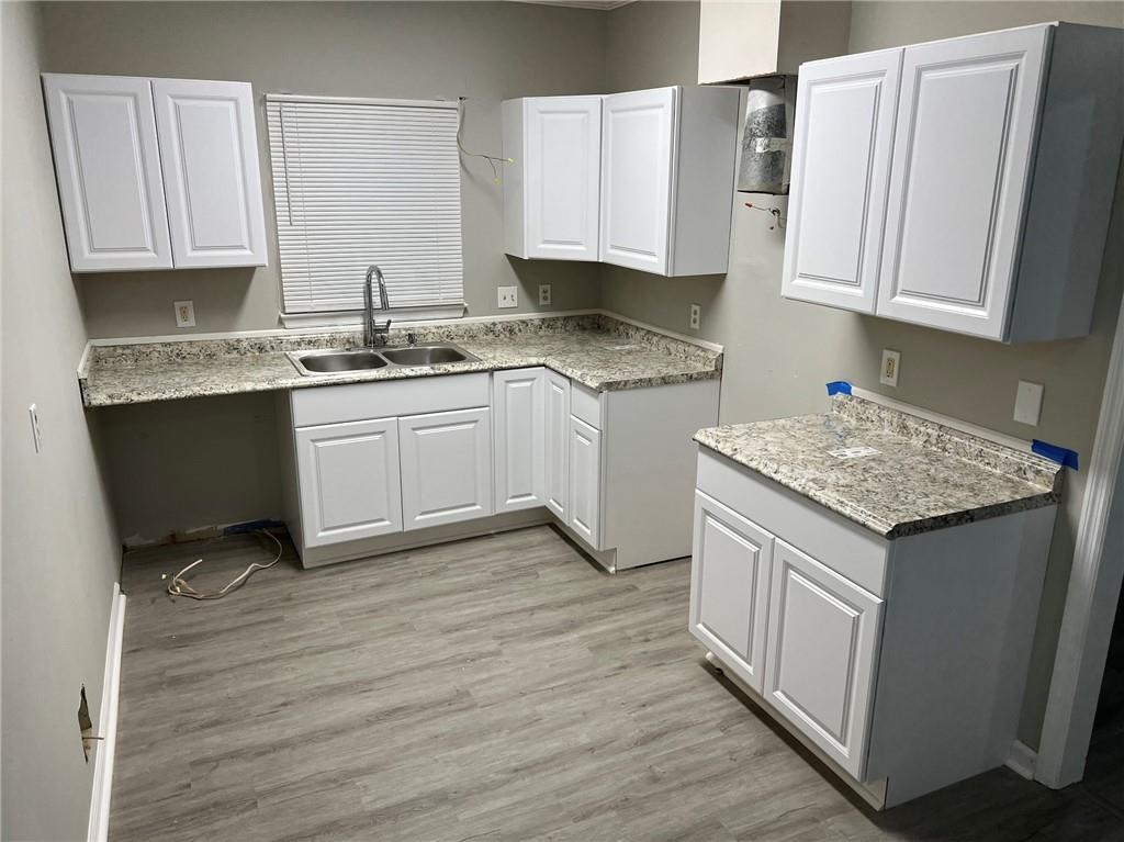 2716 Spenola Street Columbus, GA 31906 - Photo 10 of 11 a kitchen with granite countertop wooden cabinets a sink and dishwasher