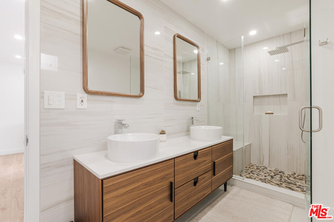 2204 Ridgemont Drive Los Angeles, CA 90046 - Photo 25 of 34 a bathroom with a sink double vanity and a mirror