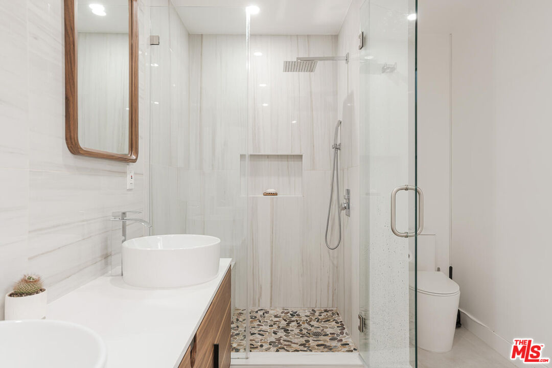 2204 Ridgemont Drive Los Angeles, CA 90046 - Photo 26 of 34 a bathroom with a sink a toilet and shower