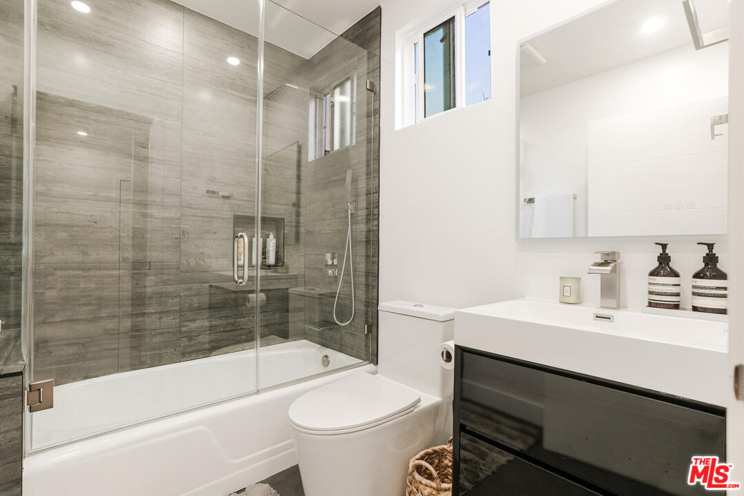2204 Ridgemont Drive Los Angeles, CA 90046 - Photo 29 of 34 a bathroom with a sink a toilet and shower
