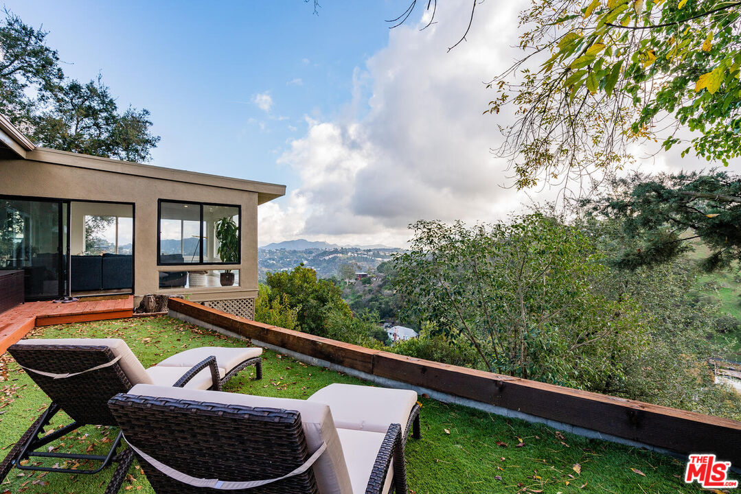 2204 Ridgemont Drive Los Angeles, CA 90046 - Photo 31 of 34 a view of a patio with couches chairs and table