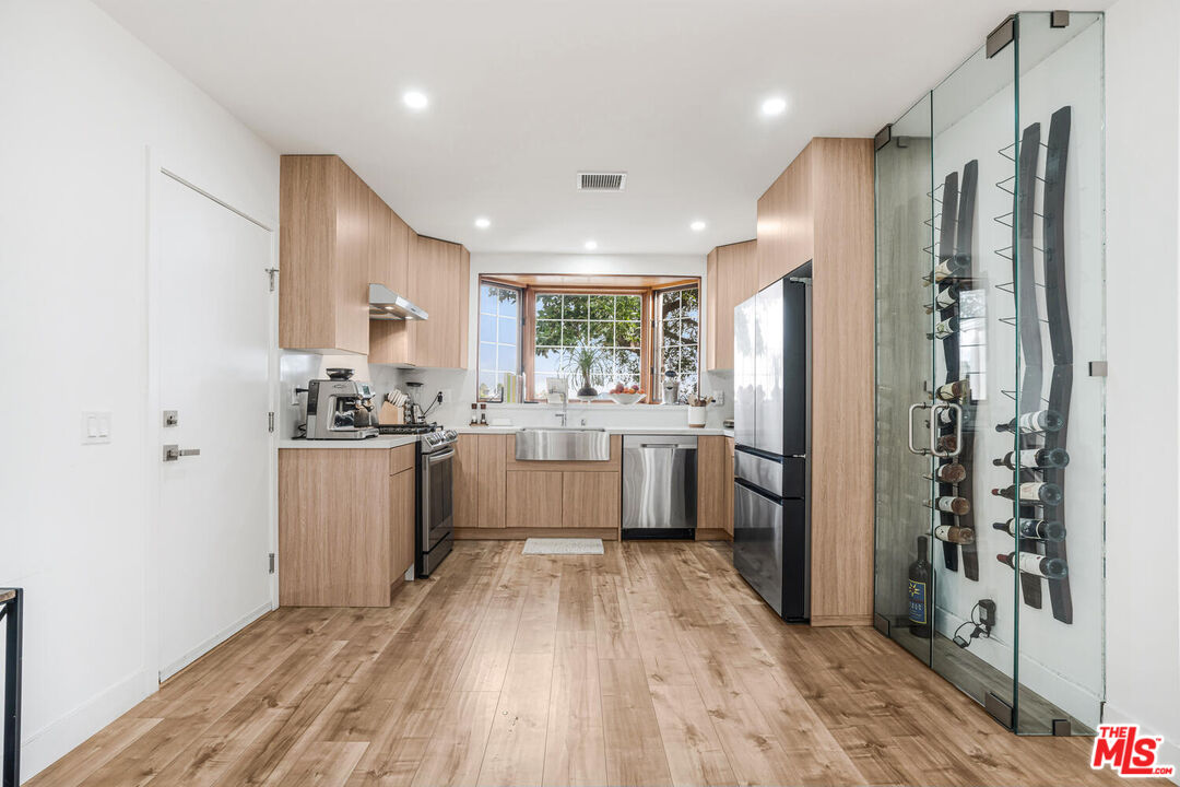 2204 Ridgemont Drive Los Angeles, CA 90046 - Photo 5 of 34 a kitchen with a refrigerator a sink and cabinets