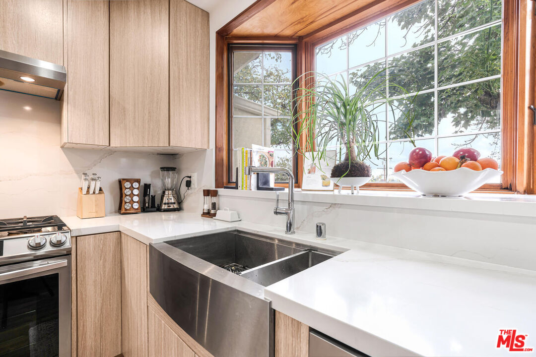 2204 Ridgemont Drive Los Angeles, CA 90046 - Photo 8 of 34 a kitchen with a sink a stove and a refrigerator