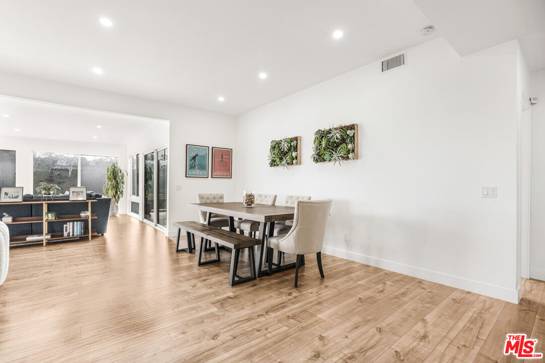2204 Ridgemont Drive Los Angeles, CA 90046 - Photo 10 of 34 a view of a dining room with furniture and chandelier floor to ceiling window