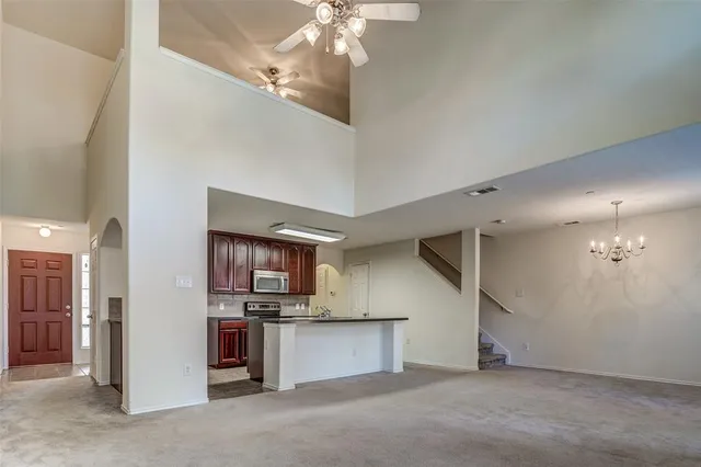 a view of a kitchen with a sink and a refrigerator