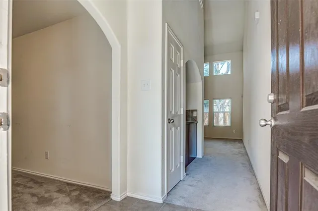 a view of a hallway with a livingroom and a bathroom