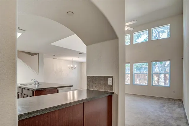 a view of a kitchen with a sink and windows