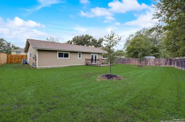 a view of a house with a backyard
