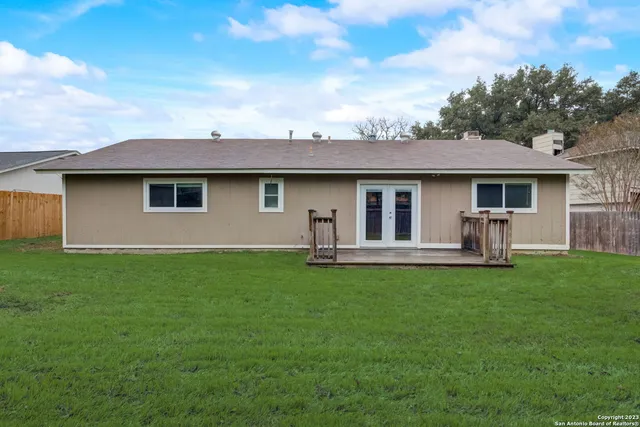 a view of a house with backyard sitting area and garden