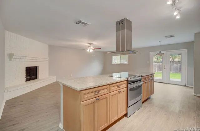 a kitchen with stainless steel appliances granite countertop a stove and a sink