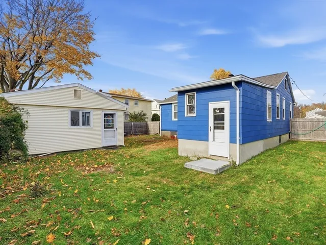 a backyard of a house with yard and outdoor seating