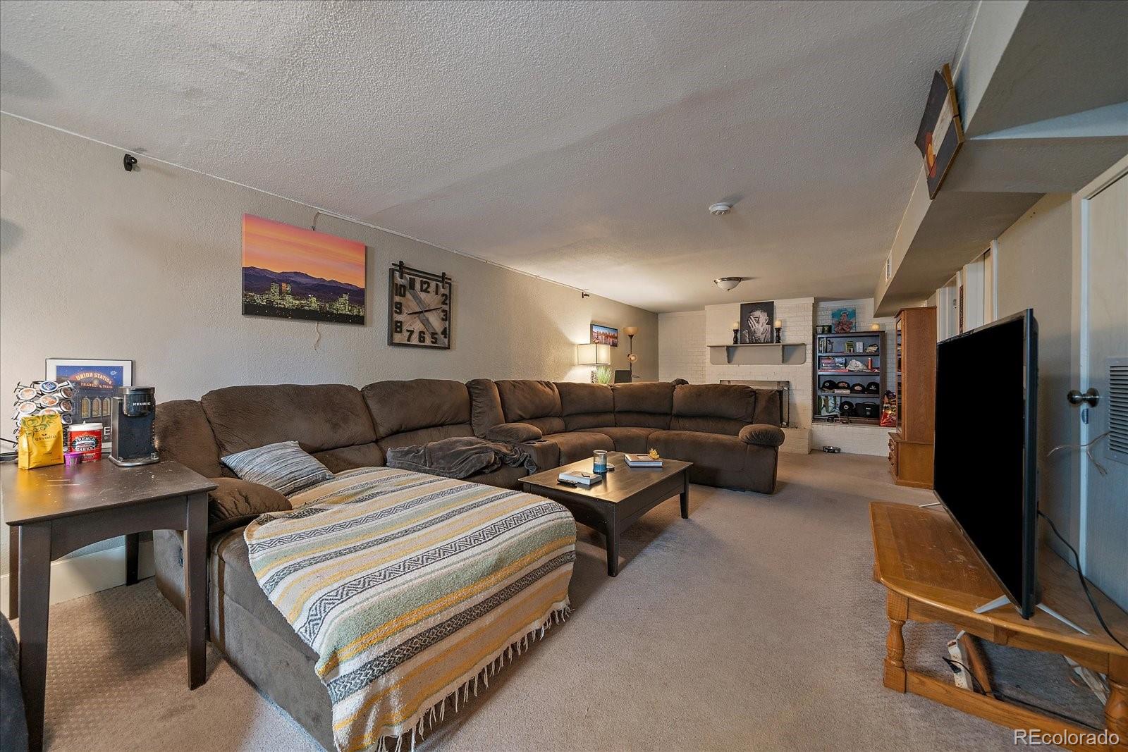 1550 South Decatur Street Denver, CO 80219 - Photo 14 of 27 a bedroom with furniture and a flat screen tv