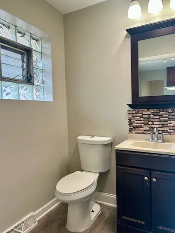 a bathroom with a sink toilet and mirror