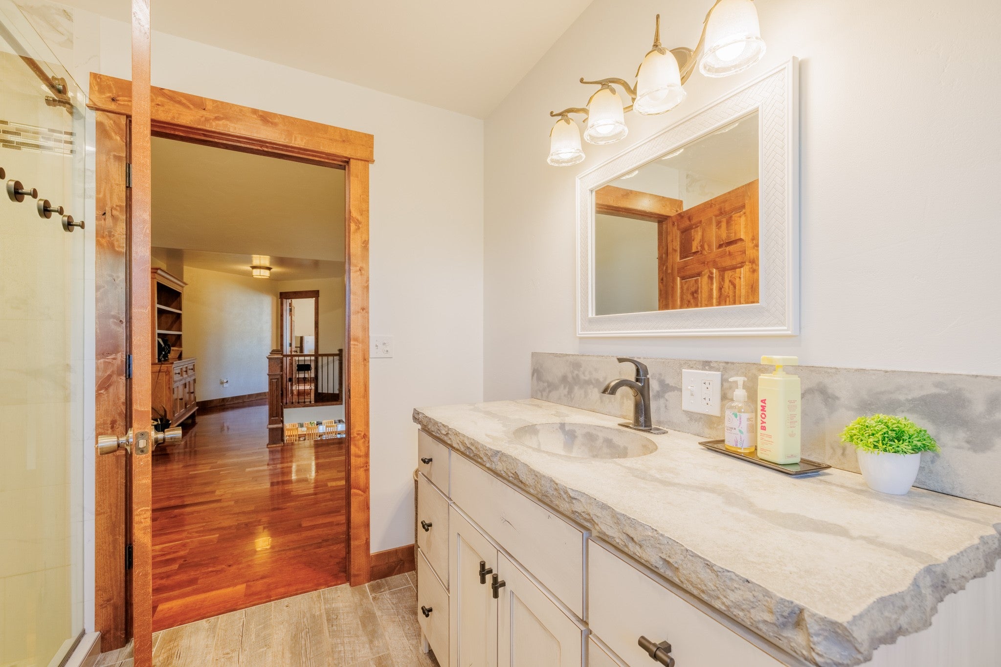 58 Gilman Road Garrison, MT 59731 - Photo 67 of 91 Full bathroom with wood finished floors, vanity, and an enclosed shower
