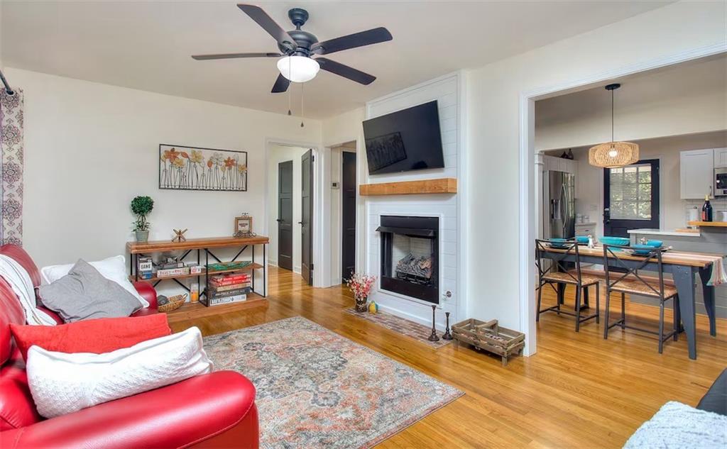 a living room with furniture a dining table and a fireplace